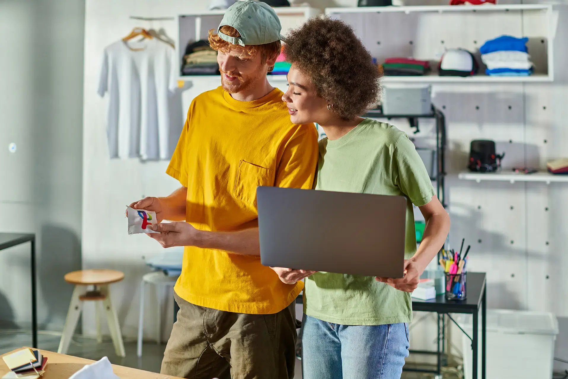 Two small business owners reviewing printed reports and laptop in a creative workspace — representing digital bookkeeping and accounting solutions in Melbourne