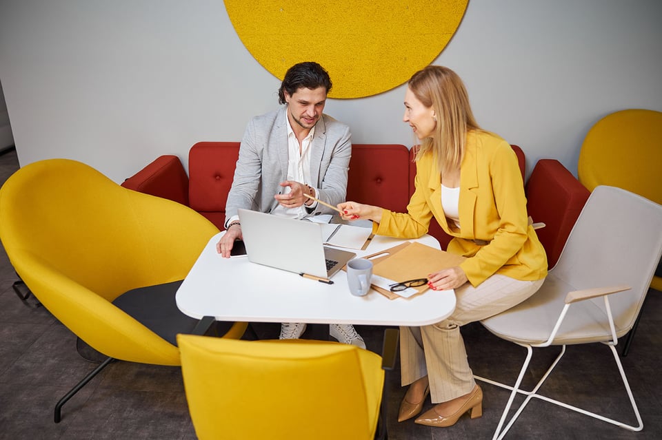 Two business professionals collaborating over a laptop in a modern office — representing 42 Advisory’s accounting and business advisory services for Melbourne businesses.