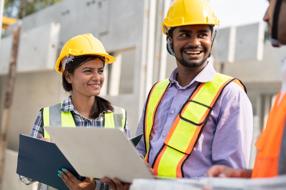 Construction professionals reviewing financial and project plans with accountants on site